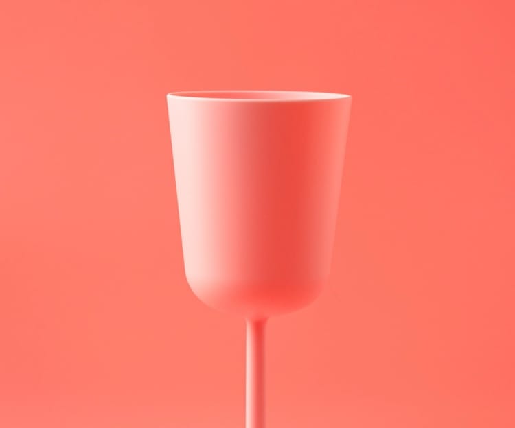 Pink wine glass on a pink background